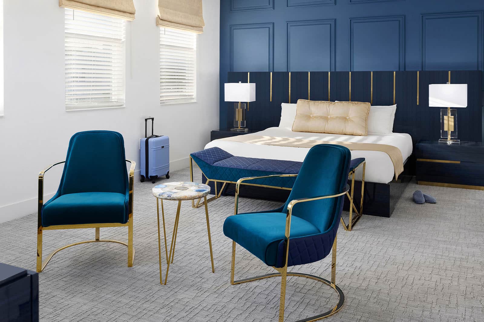 master suite bedroom with seating area in front of bed