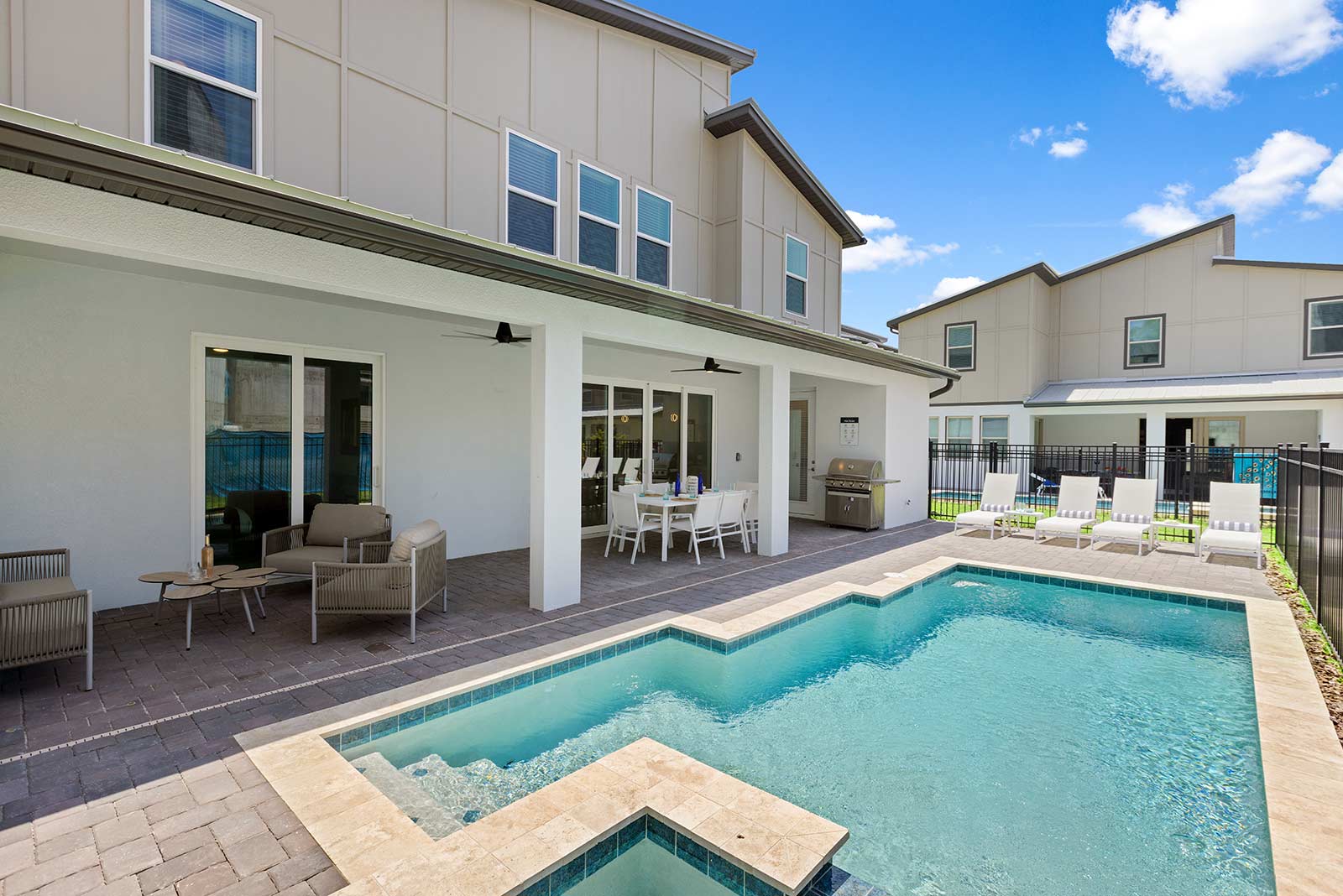 backyard pool with dining table on the patio
