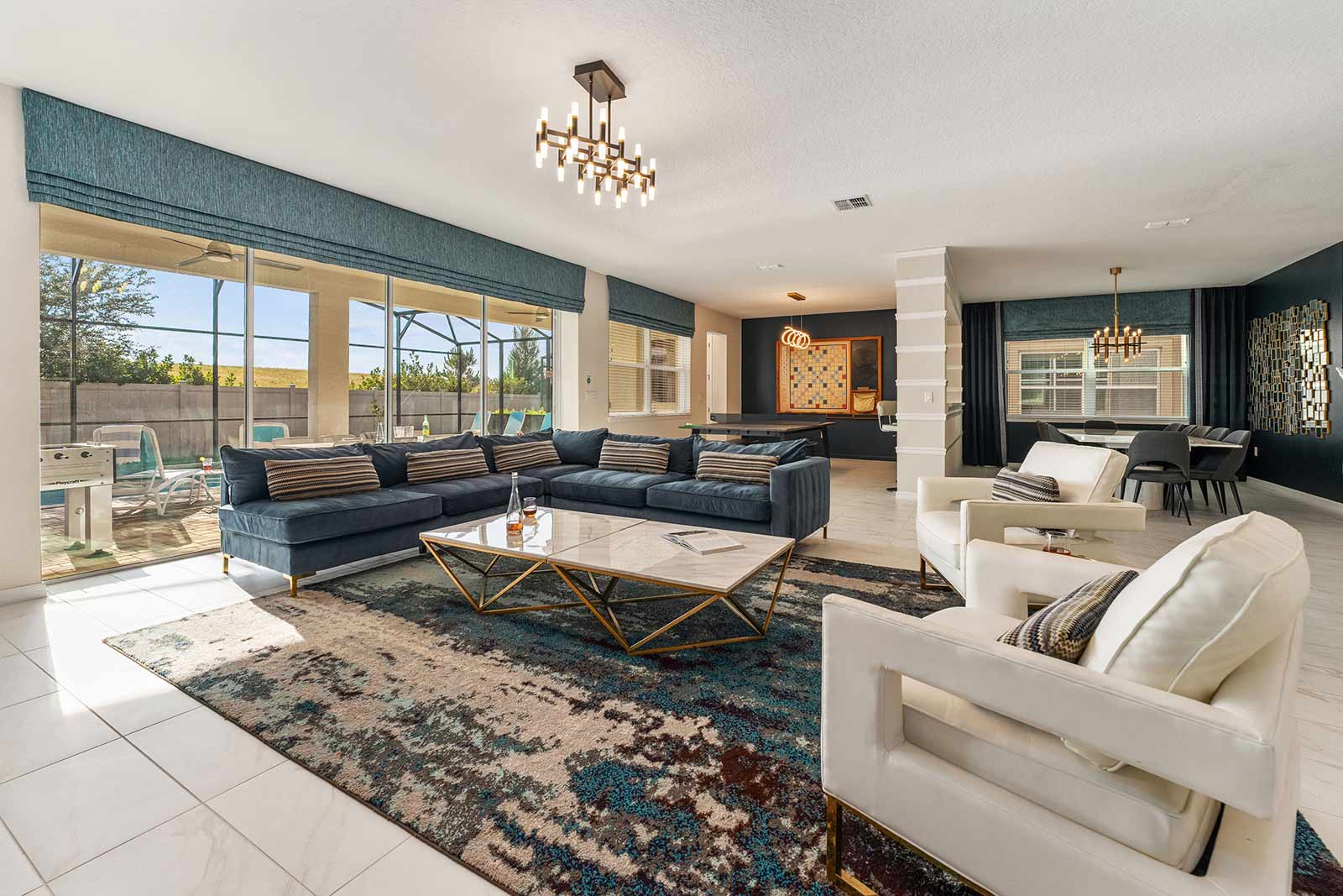 living room blue couch and white chairs