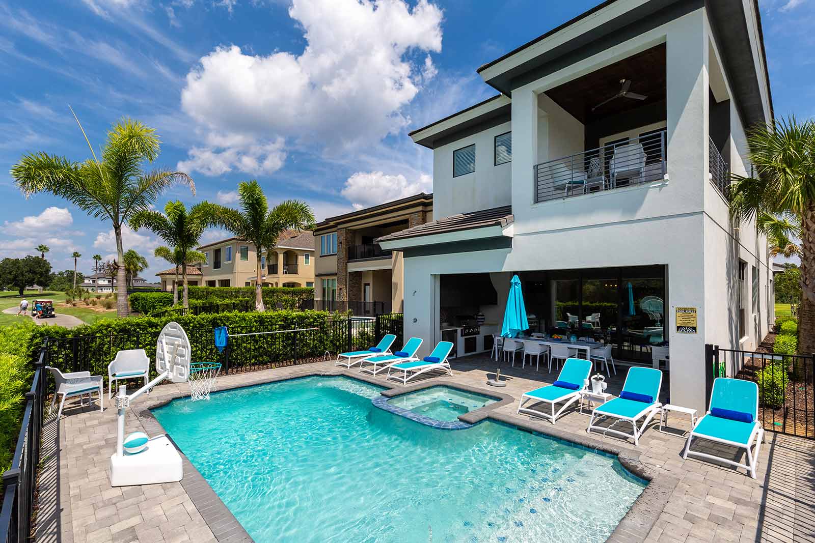 backyard with pool, spa, and lounge chairs