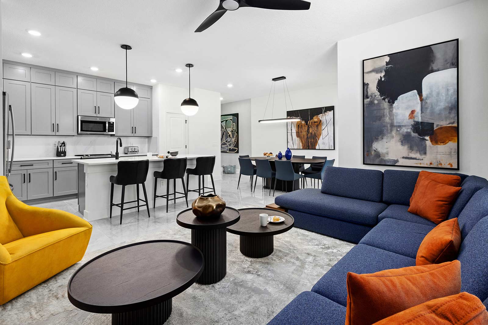 living room with blue couch overlooking kitchen