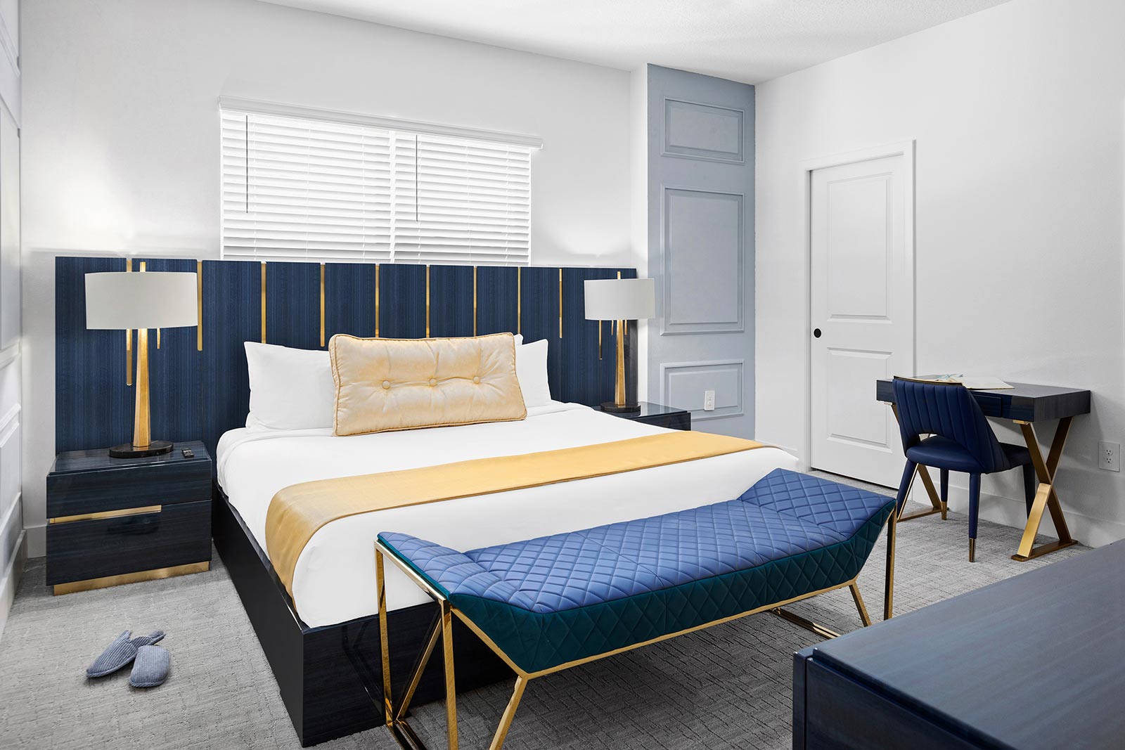 master bedroom with desk and couch at end of bed