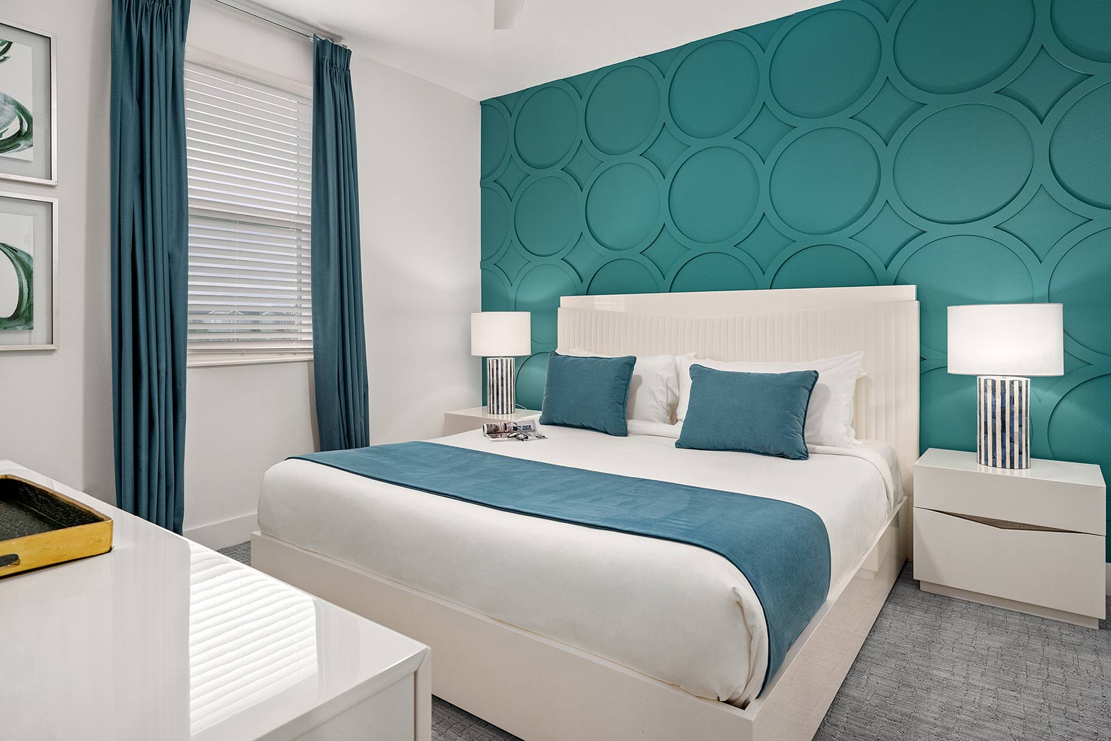 bedroom with king bed and teal patterned wall