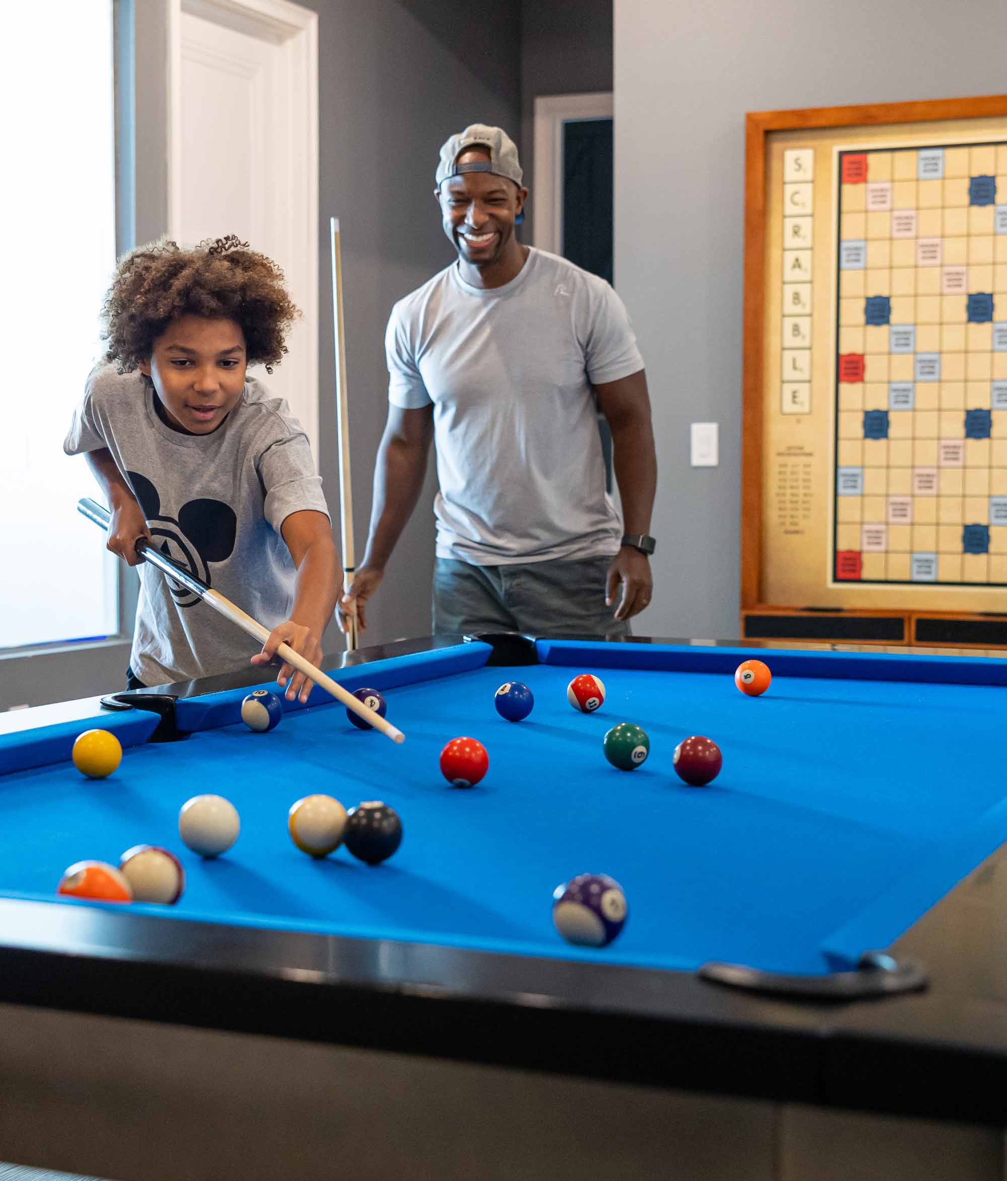 father and son playing pool