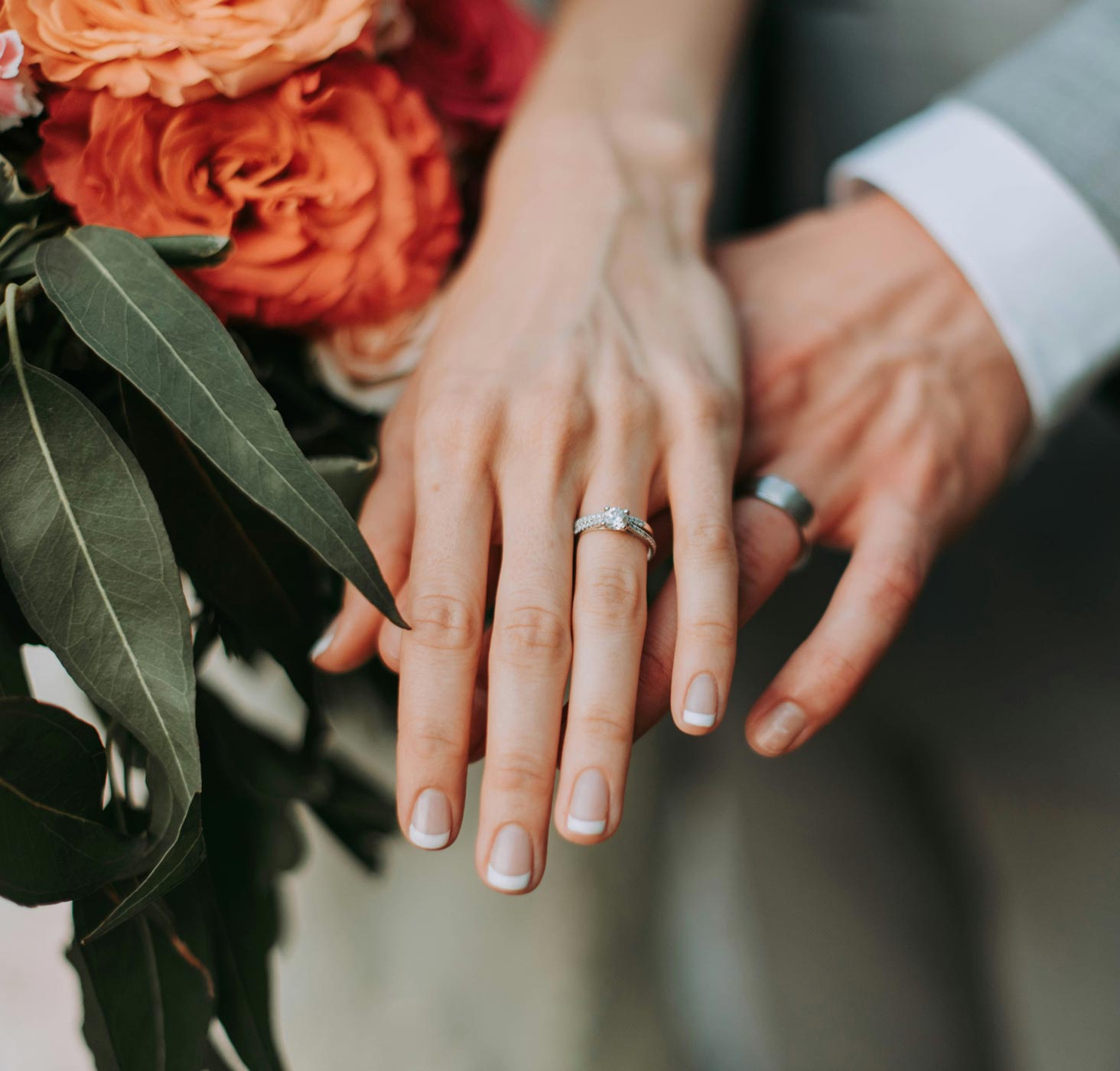 couple holding hands showing wedding rings