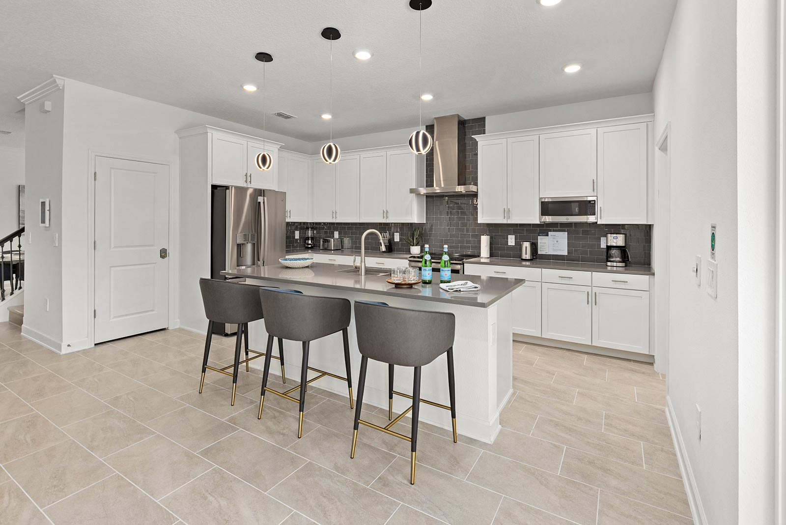 kitchen with island and 3 stools