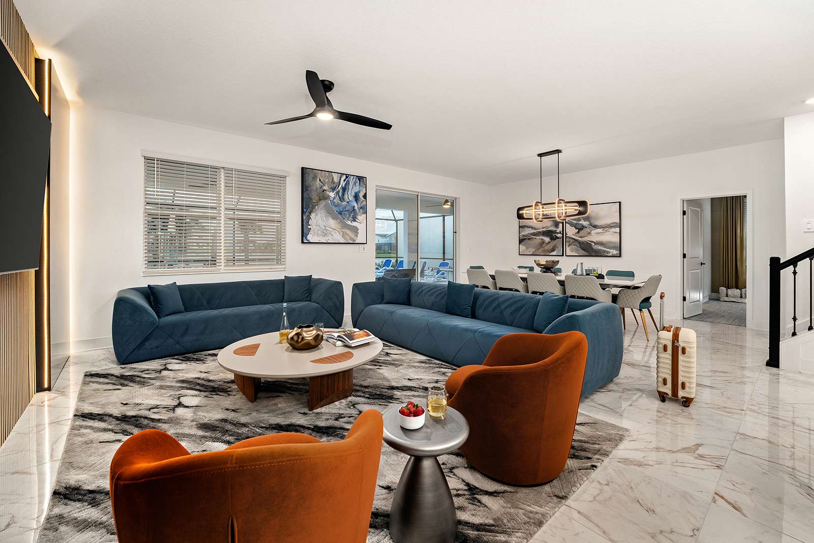 living room with blue couches and orange chairs