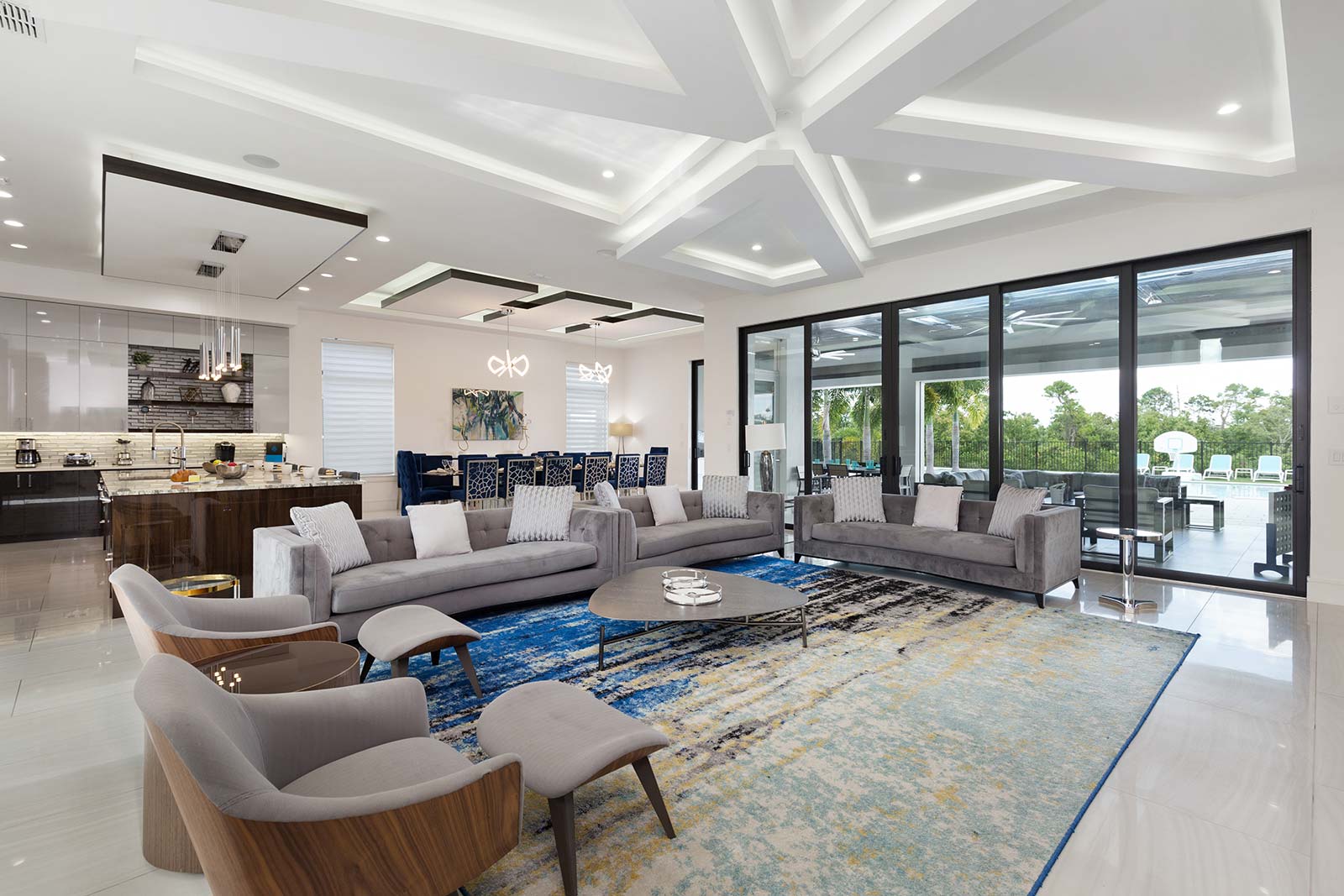 living room with 2 couches and chairs with foot rests