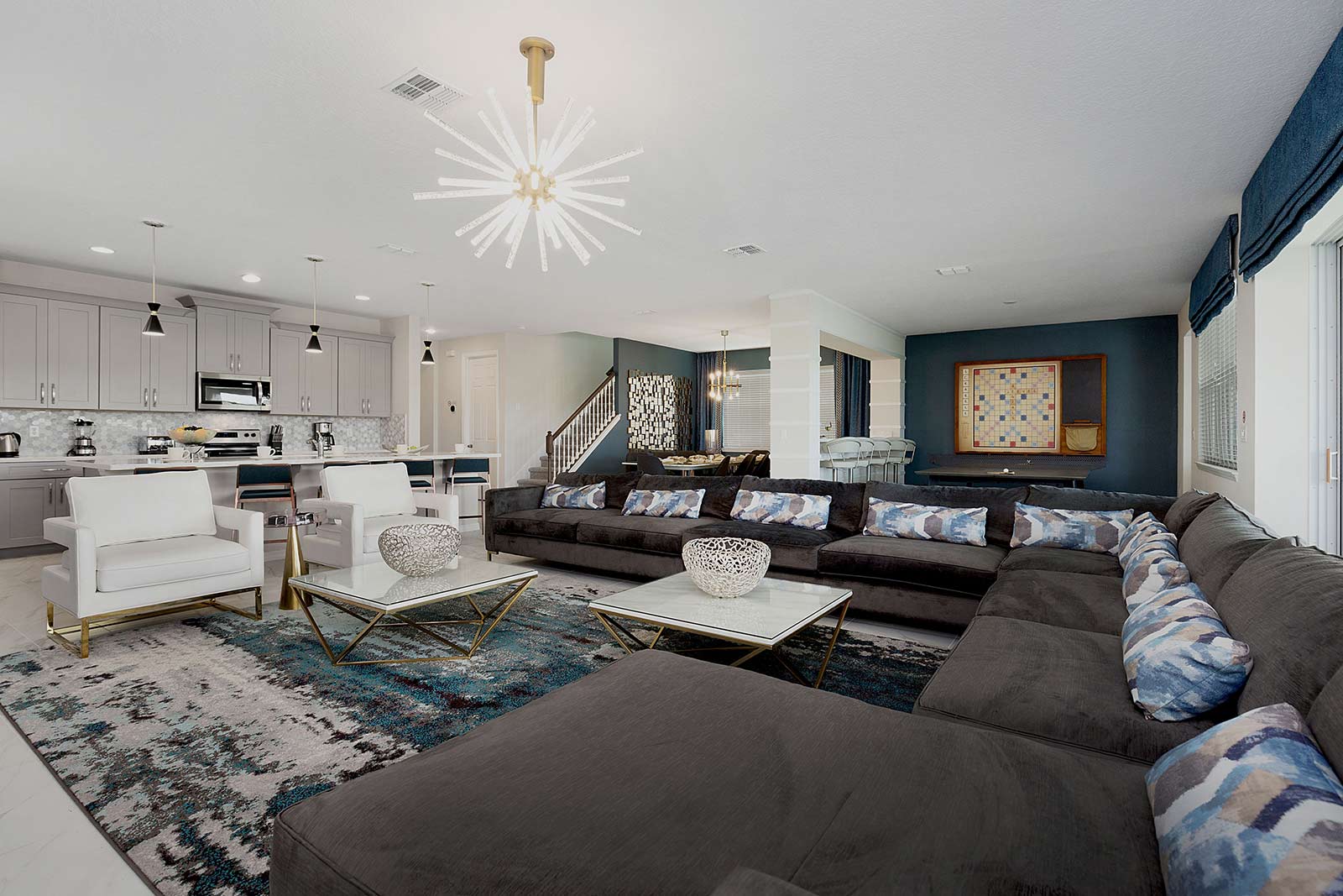 living room with large sectional couch and 2 white chairs