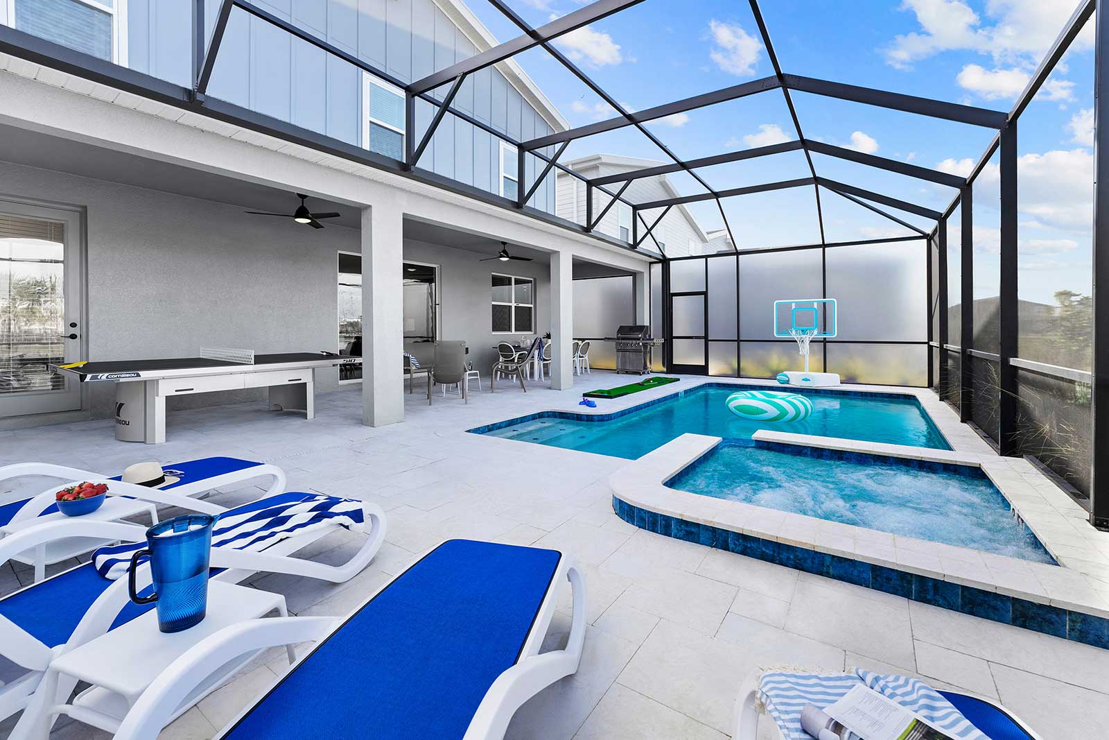 pool and spa with lounge chairs and lounge area