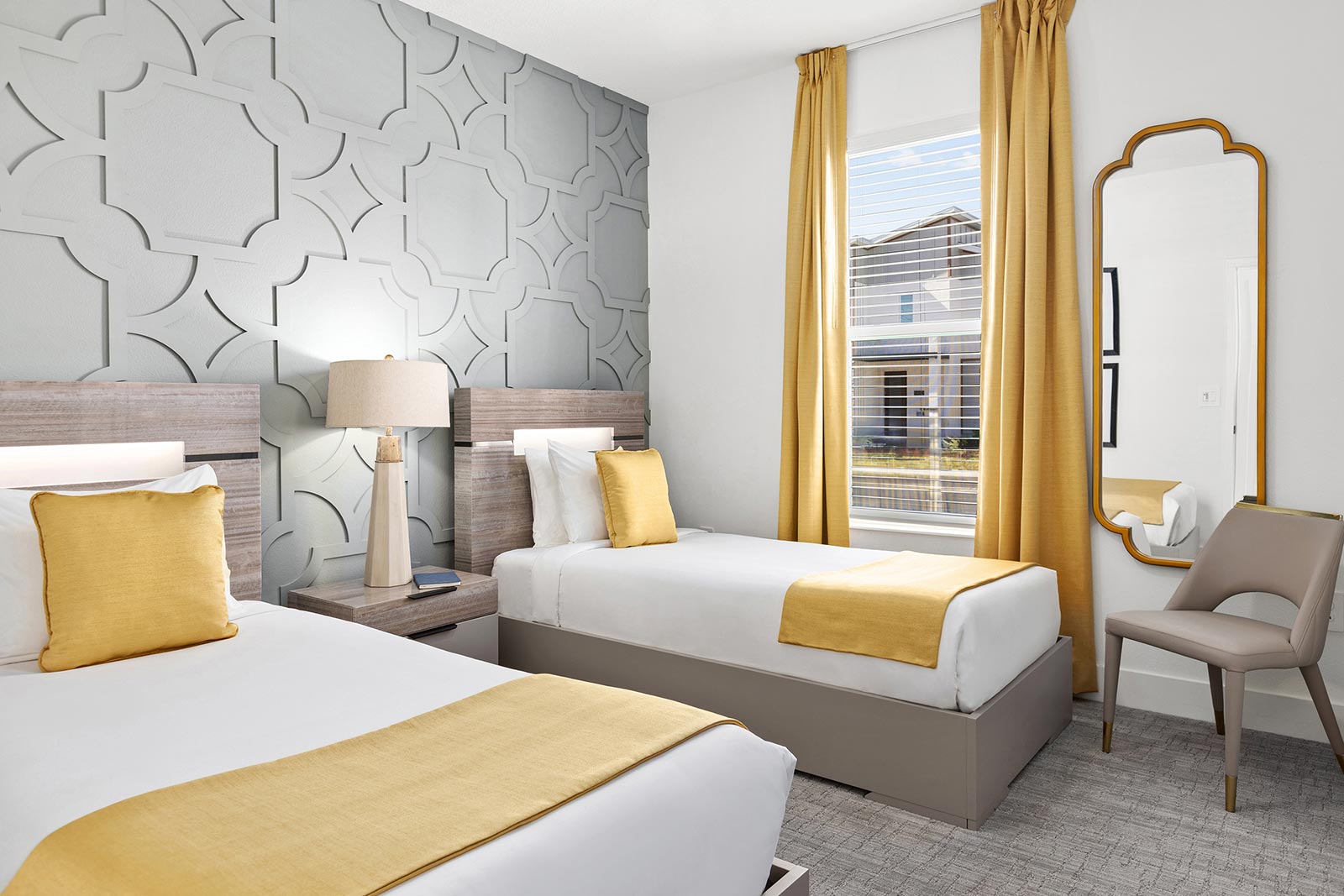 bedroom with 2 full beds and gray background wall