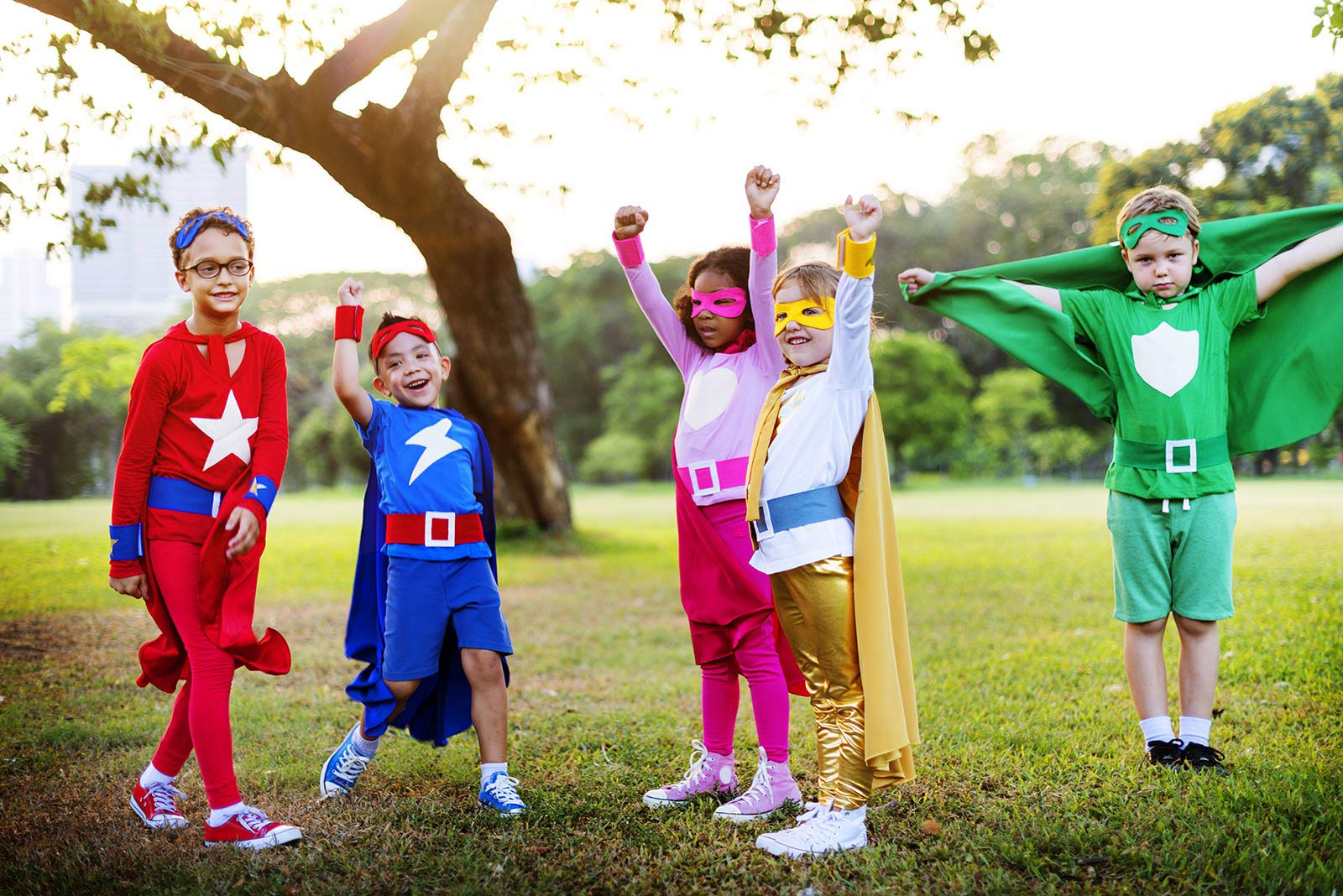kids playing outside in homemade superhero costumes