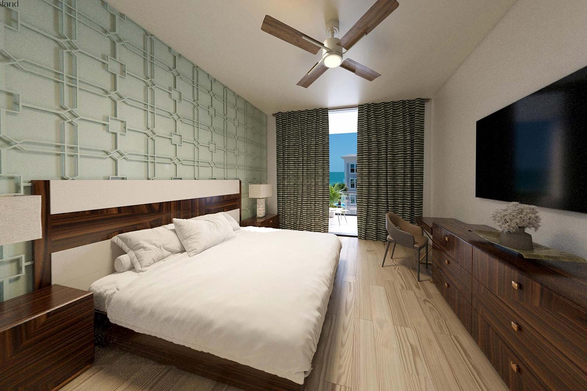 condo bedroom with king bed and green accent wall with balcony view