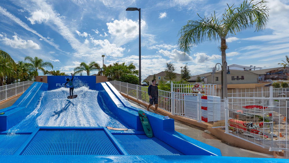man riding on a surf simulator