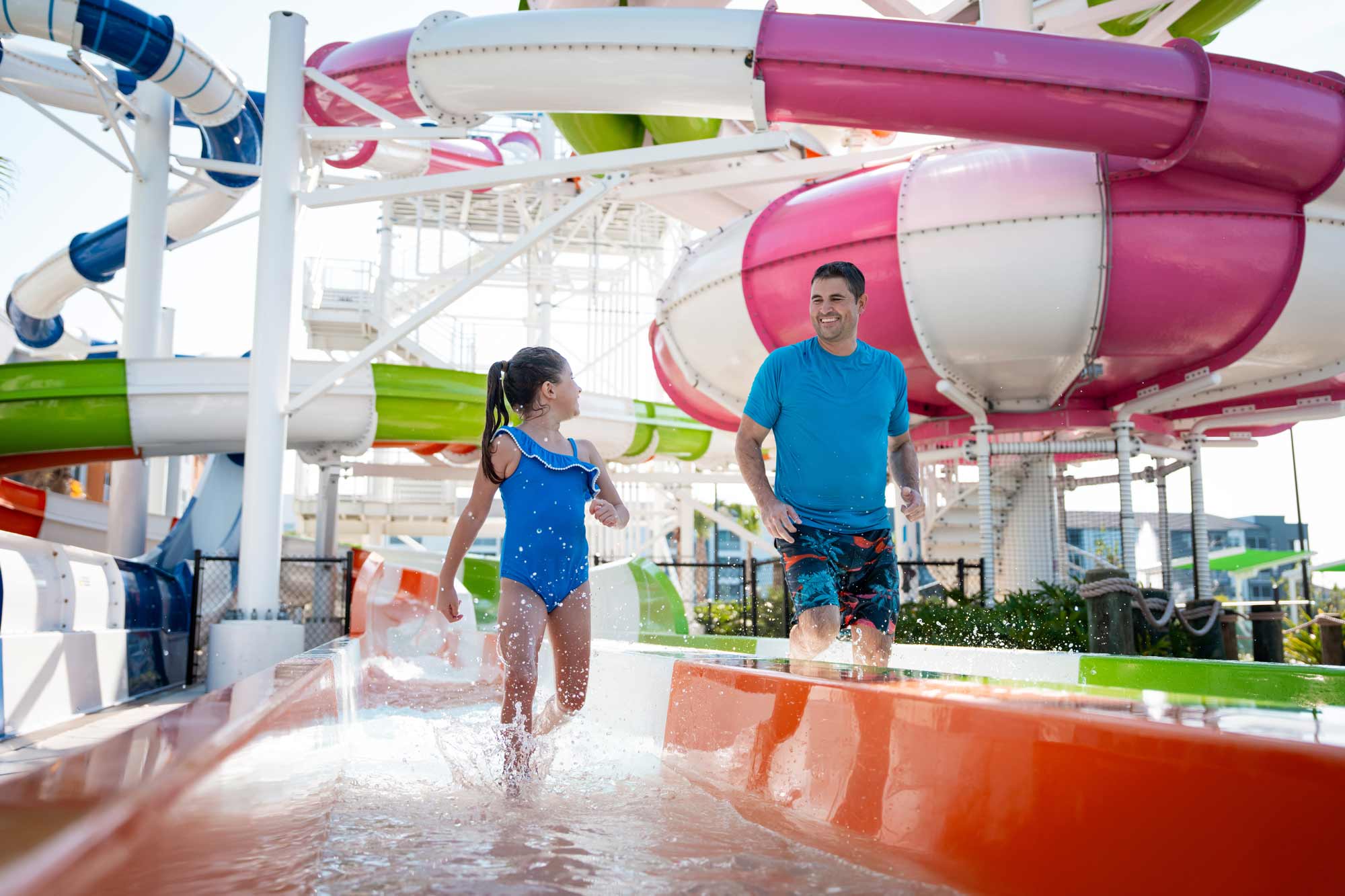 father and daughter exiting a waterslide